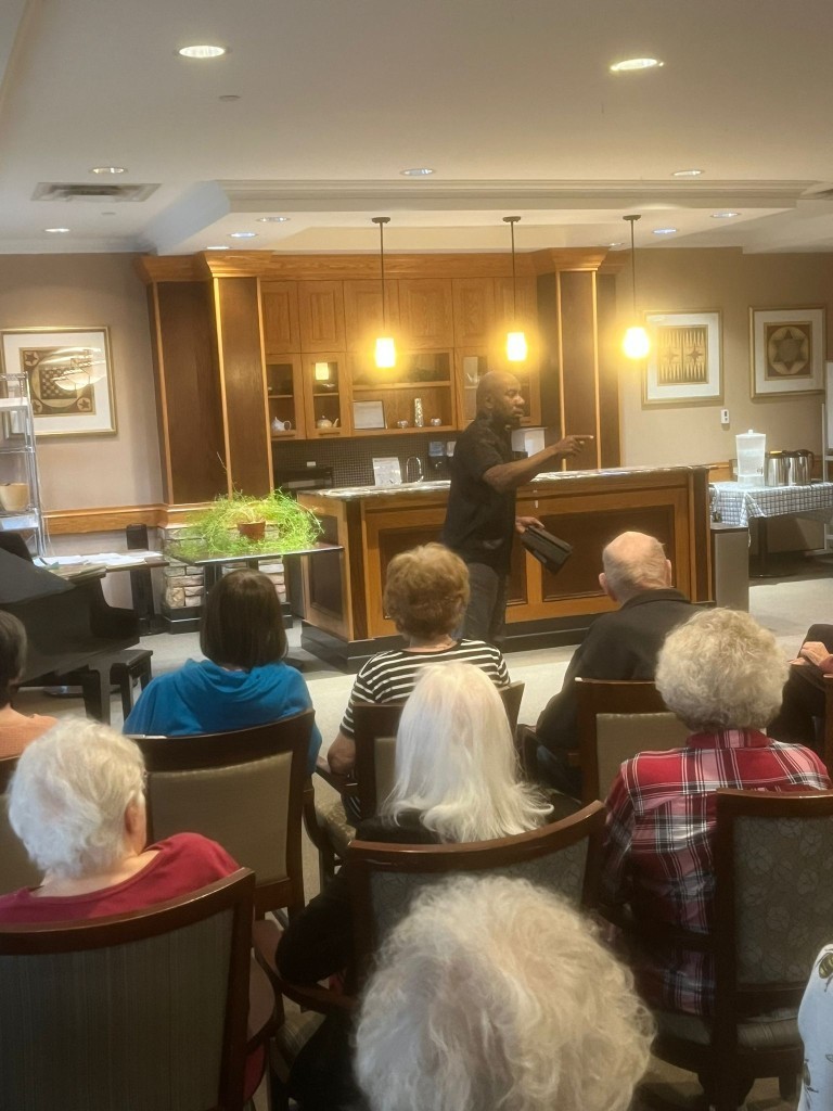 Johnson Philip speaking to an audience of seniors