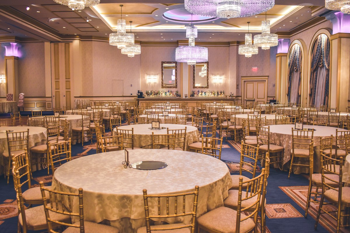 Elegant ballroom set for a corporate gala with live piano music