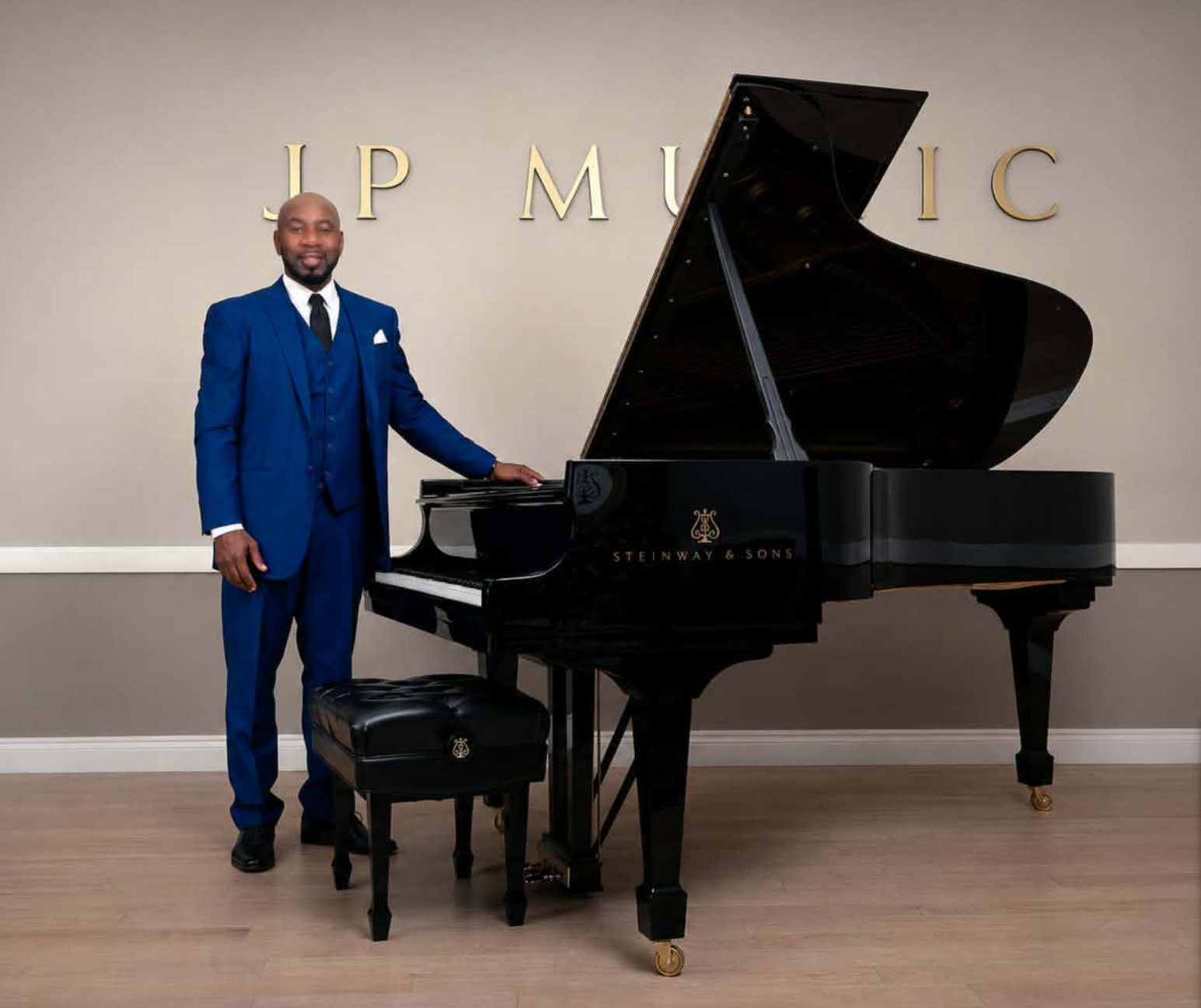 Johnson Philip standing beside a grand piano